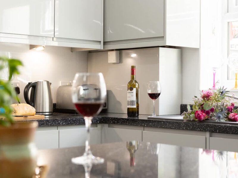 Kitchen with wine and flowers at Townhouse Harbour Retreat.