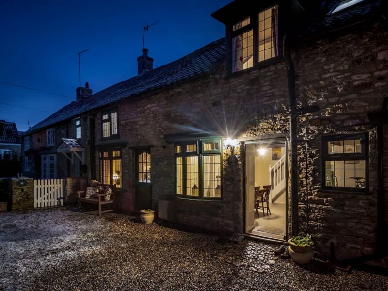 Garth Cottage: Dog-friendly village holiday let with inviting exterior lighting.