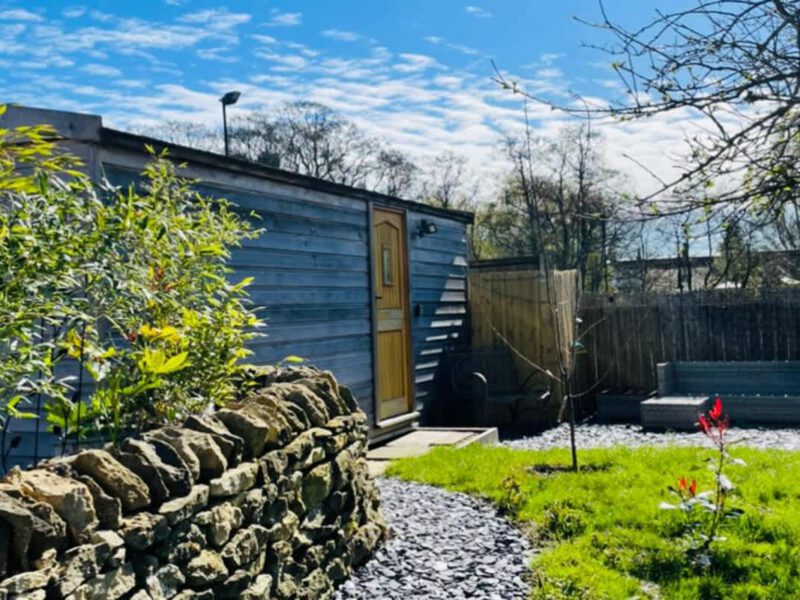 Cosy Shepherd's Hut farm stay with outdoor seating area.