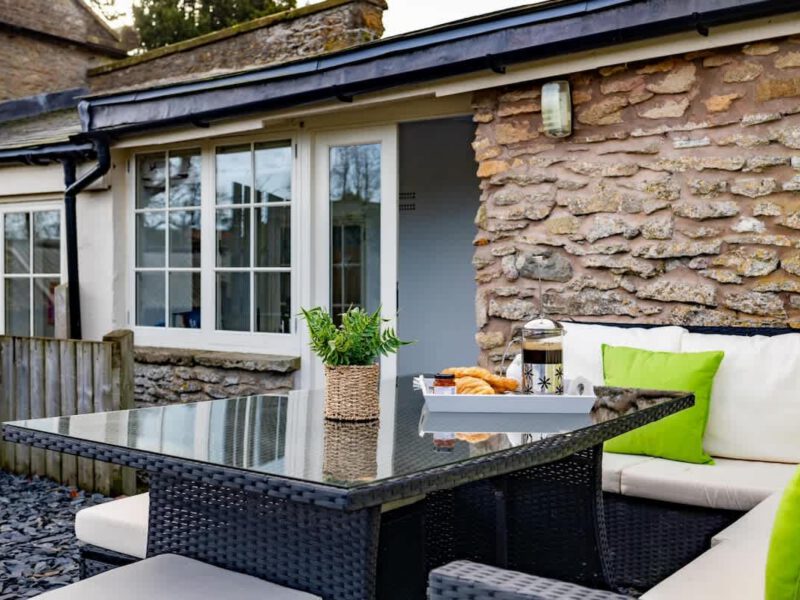 Outdoor seating area with coffee and pastries at Yew Tree Cottage farm stay.