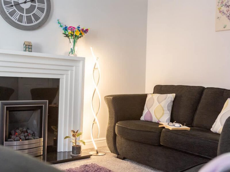 Cozy living area with fireplace and sofa at Townhouse Harbour Retreat.