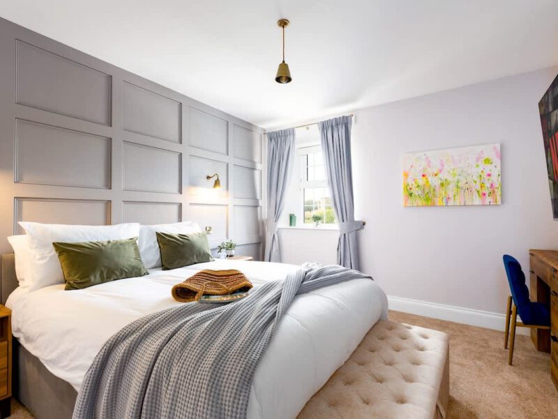 Stylish bedroom at Castle View Cottage with Netflix TV and EV charger.