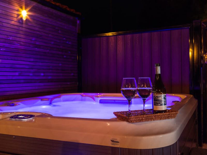 Hot tub with wine and glasses at Castle View Cottage, a holiday let.