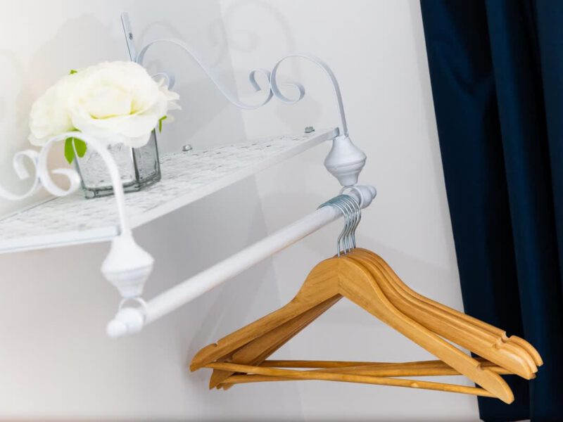 Wooden hangers and floral decor in Coastal Village Hideaway accommodation.
