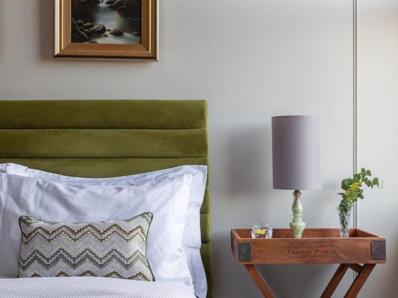 Comfortable bed with artwork at Crescent View holiday let.