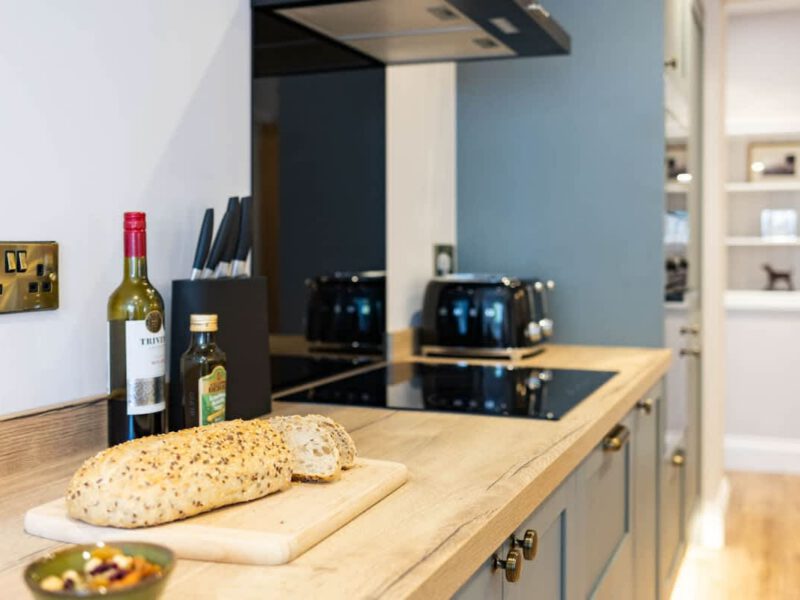 Modern kitchen with bread and wine at Castle View Cottage.