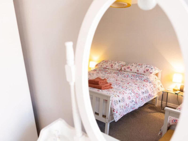 Cozy bedroom with patterned duvet at Townhouse Harbour Retreat.