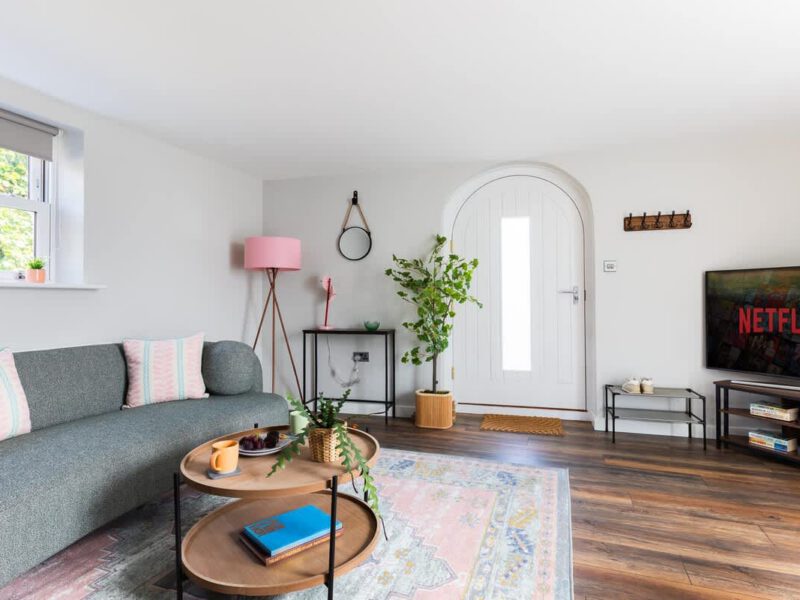 Cozy living area with sofa and TV at Ivy Mews barn holiday let.