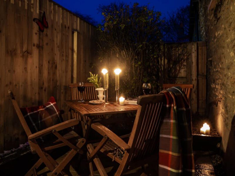 Cozy outdoor seating area at Garth Cottage, perfect for dog-friendly village stays.