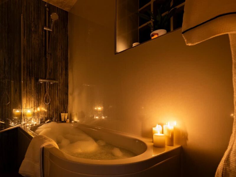 Relaxing bubble bath with candles at Yew Tree Cottage farm stay.