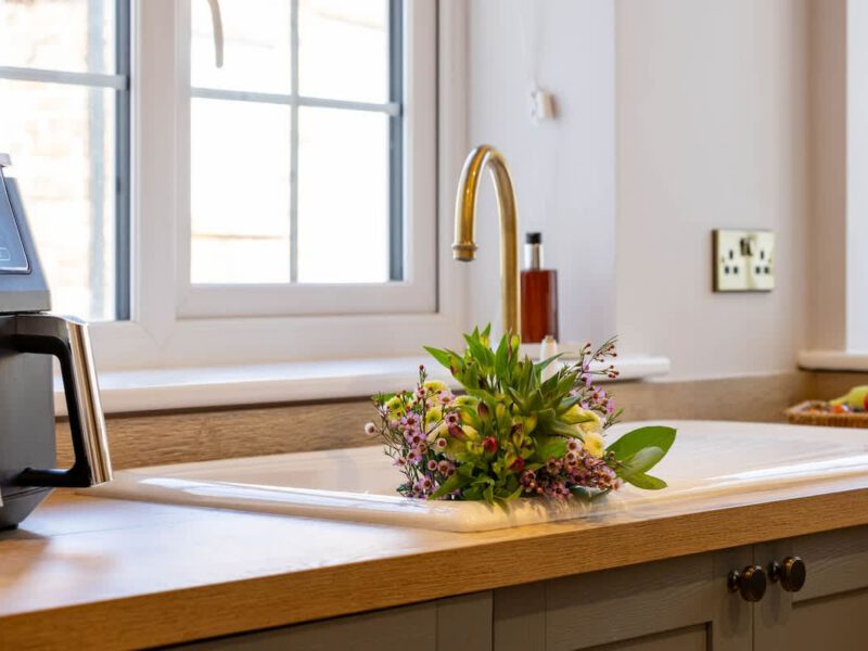 Kitchen sink with flowers at Castle View Cottage.