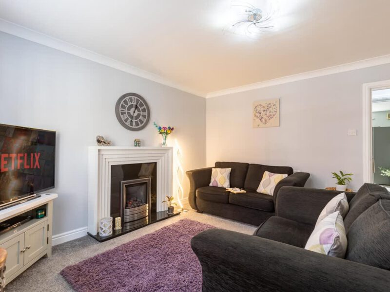 Comfortable living room with fireplace and Netflix TV at Townhouse Harbour Retreat.