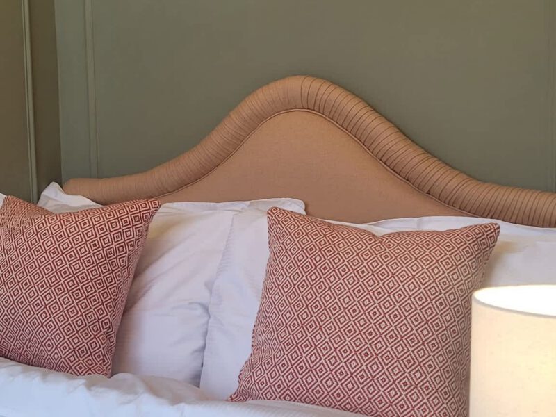 Comfortable double bed with decorative pillows at Crescent View holiday let.