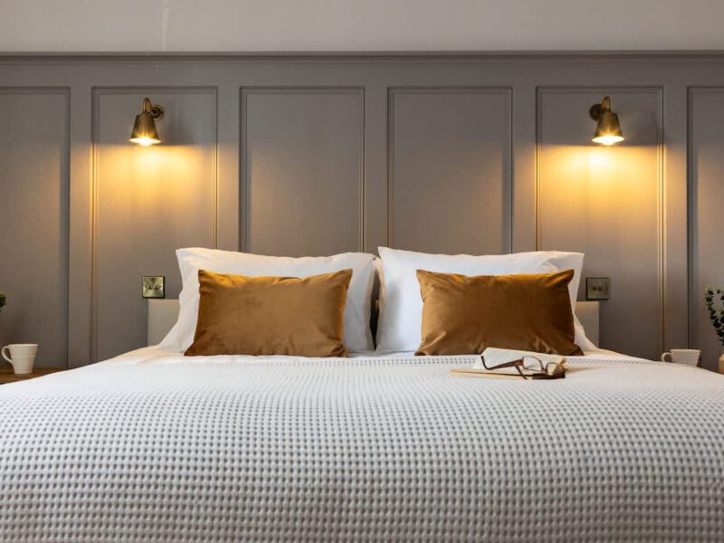 Comfortable bed with bedside lamps at Castle View Cottage.