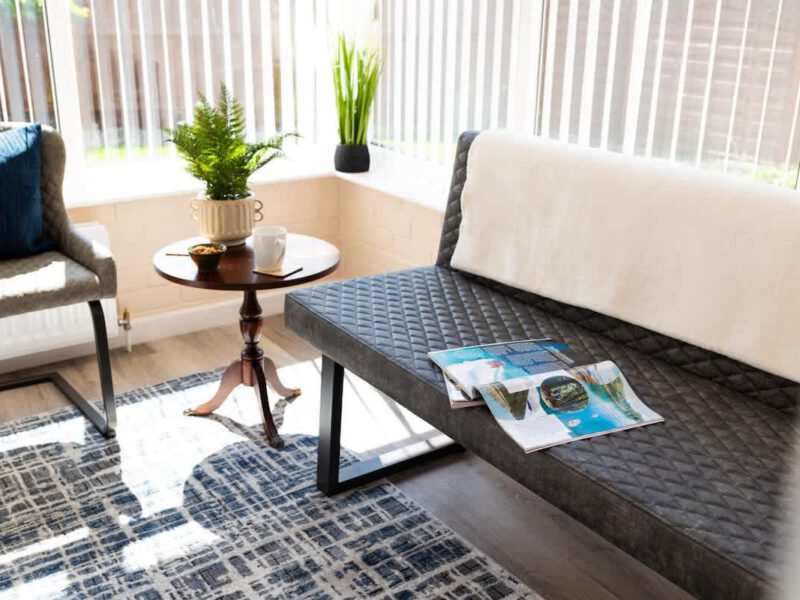 Comfortable seating area with magazines at Coastal Village Hideaway holiday let.