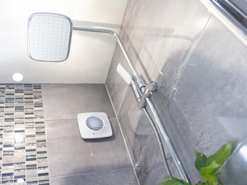Modern shower with mosaic tile accents at Townhouse Harbour Retreat.
