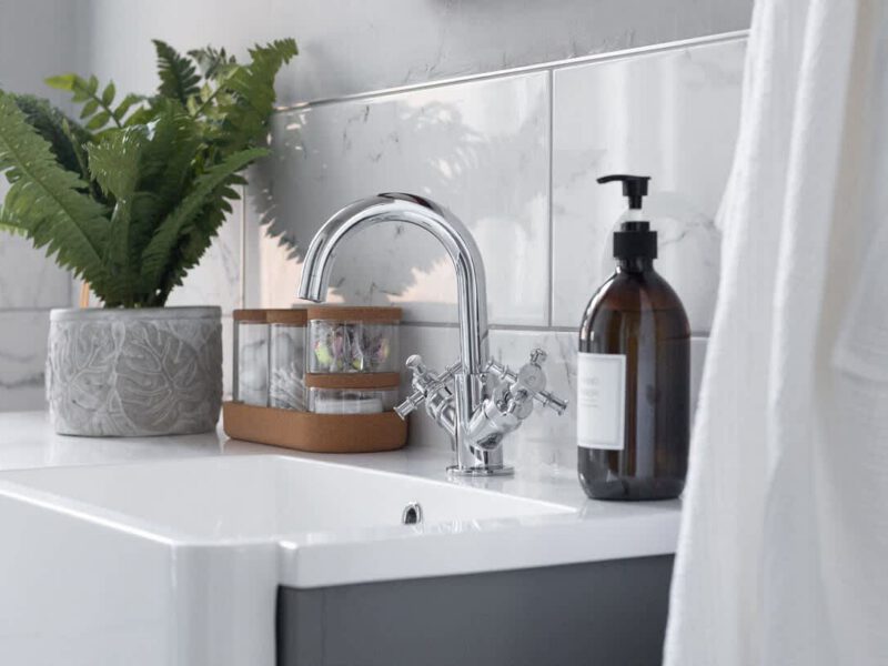 Stylish bathroom sink with chrome tap and toiletries at Crescent View holiday let.