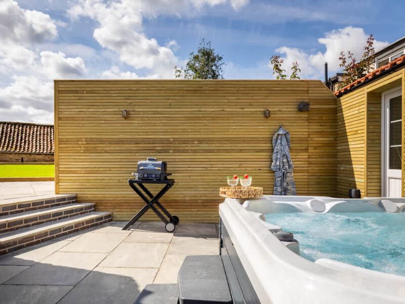 Hot tub and grill on patio at Castle View Cottage, a holiday let.