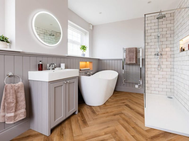 Modern bathroom with freestanding tub and walk-in shower at Castle View Cottage.