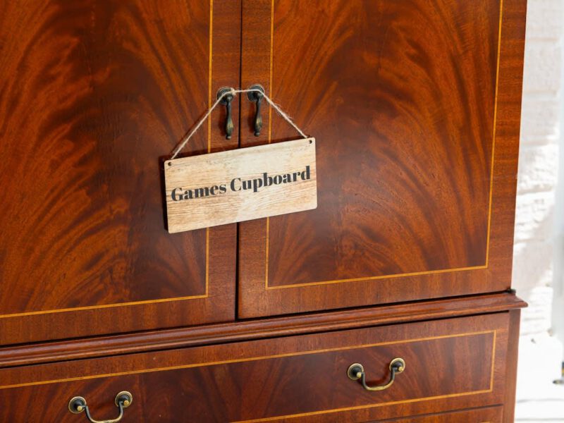 Games cupboard in Coastal Village Hideaway holiday let.