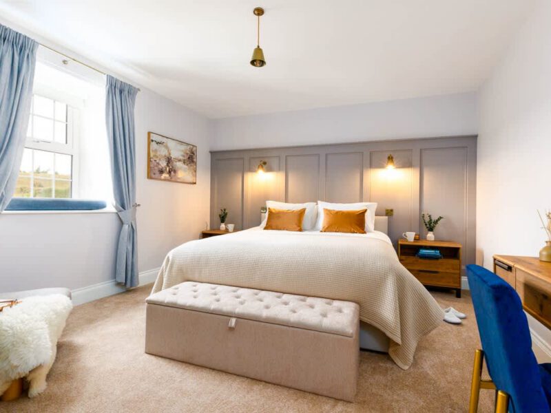 Luxurious bedroom at Castle View Cottage with king-size bed and ensuite facilities.