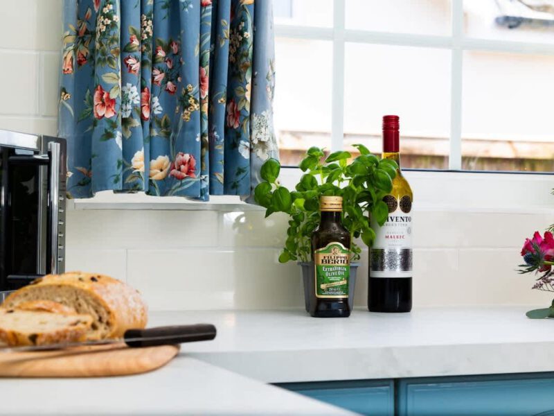 Kitchen counter with bread, olive oil, and wine at Coastal Village Hideaway.