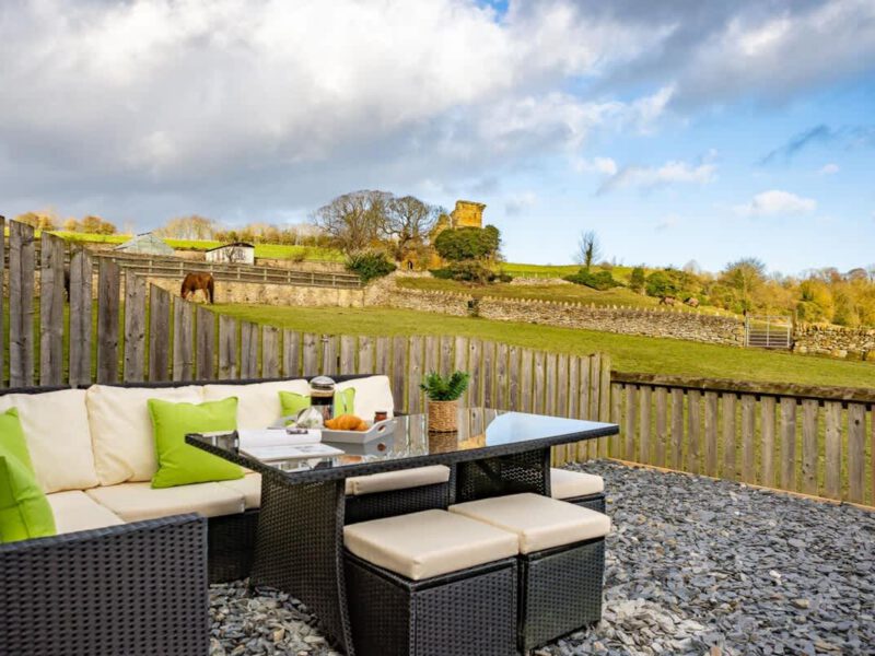 Patio seating with countryside views at Yew Tree Cottage farm stay.