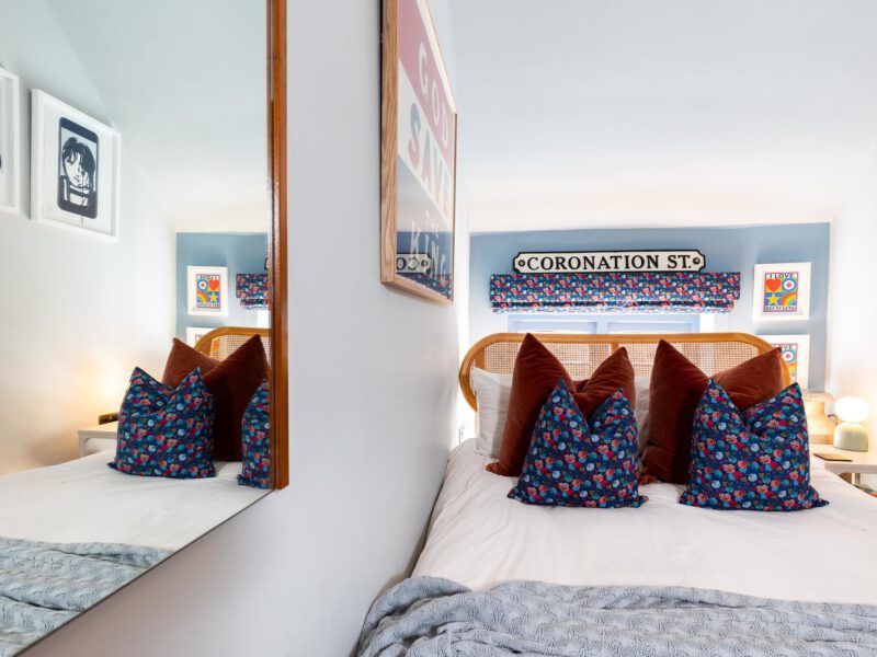 Stylish bedroom with Coronation St sign at The Loft by the Bay holiday let.