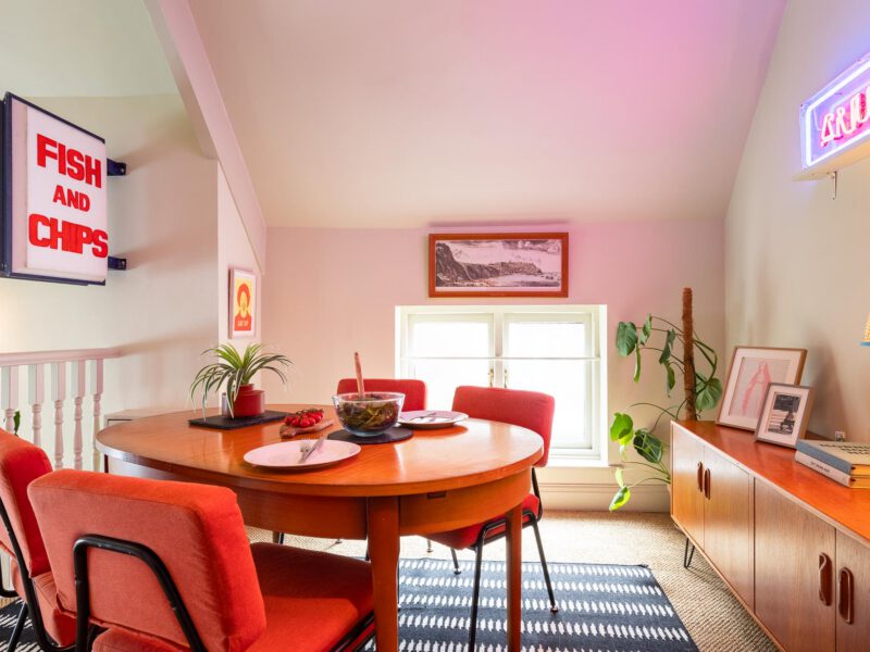 Dining area with retro decor at The Loft by the Bay holiday let.