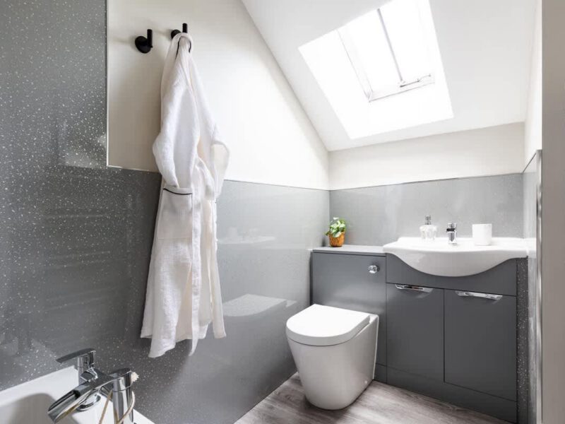 Modern bathroom with fluffy bathrobe at Ivy Mews barn holiday let.