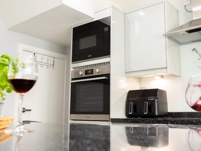 Modern kitchen with built-in oven and microwave at Townhouse Harbour Retreat.