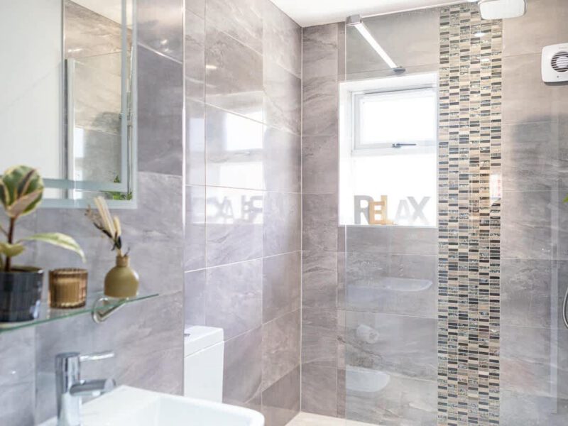 Modern bathroom with stylish grey tiles and a walk-in shower at Townhouse Harbour Retreat.