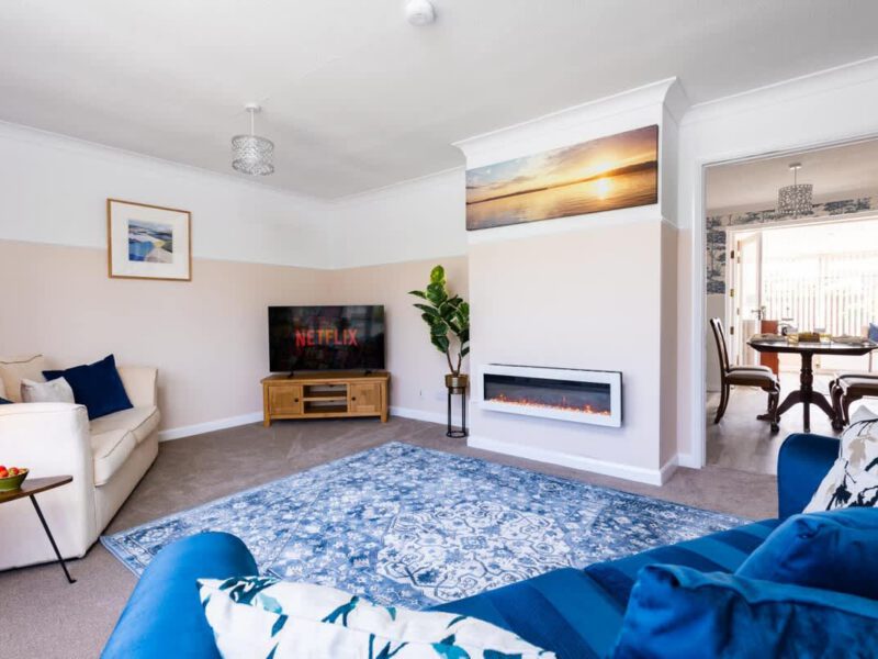 Comfortable living area with fireplace and dining nook at Coastal Village Hideaway.
