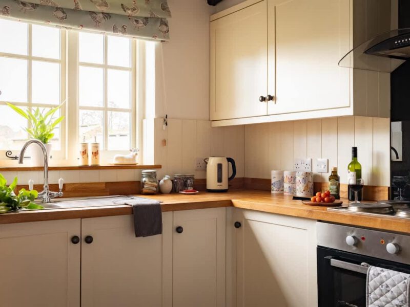 Bright kitchen with wooden countertops at Yew Tree Cottage farm stay.
