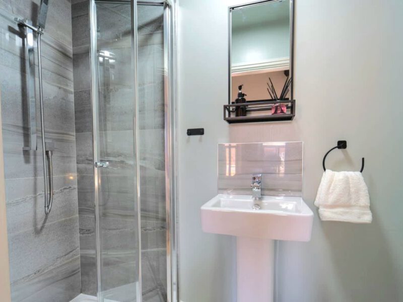 Modern bathroom with shower and sink at Old Town House.