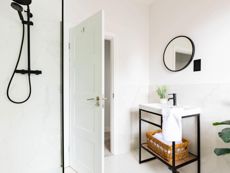 Modern bathroom with walk-in shower and vanity at Ocean Pearl holiday let.