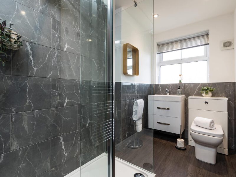 Modern bathroom with marble tiles in the Penthouse Suite.