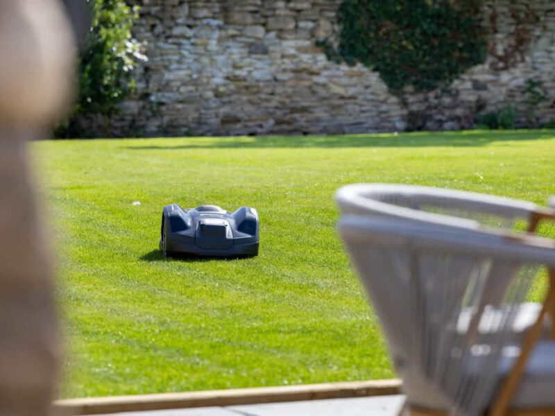 Robotic lawnmower on manicured lawn at Castle View Cottage.