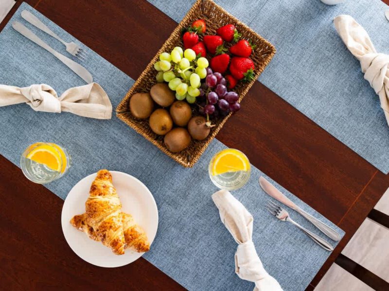 Fresh breakfast spread with croissants and fruit at Coastal Village Hideaway.