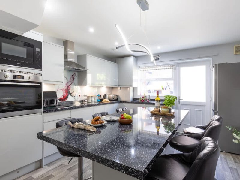 Modern kitchen island with seating at Townhouse Harbour Retreat holiday let.