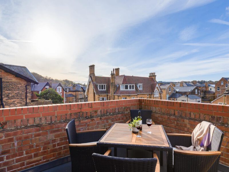 Penthouse Suite balcony with town views and outdoor seating.