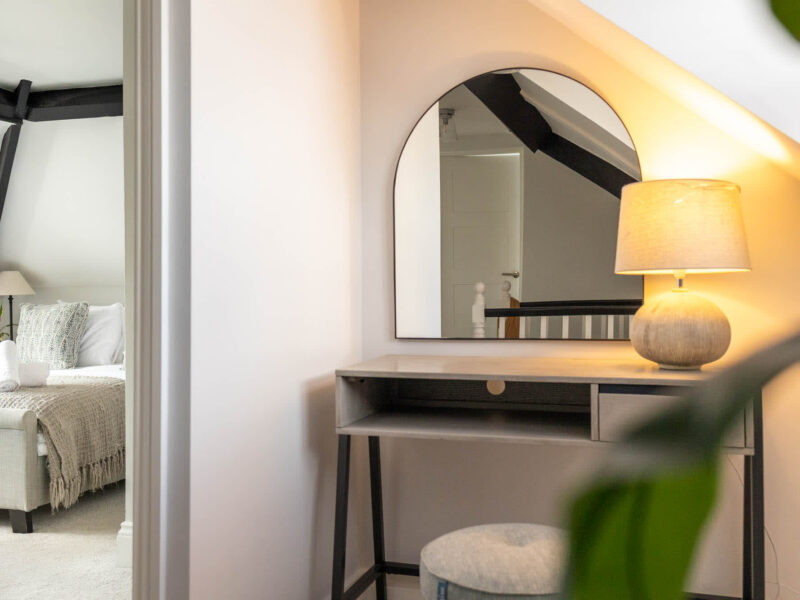 Bedroom dressing area with arched mirror at Ocean Pearl holiday let.