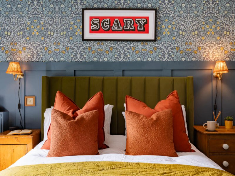 Stylish bedroom with quirky art at The Loft by the Bay holiday let.