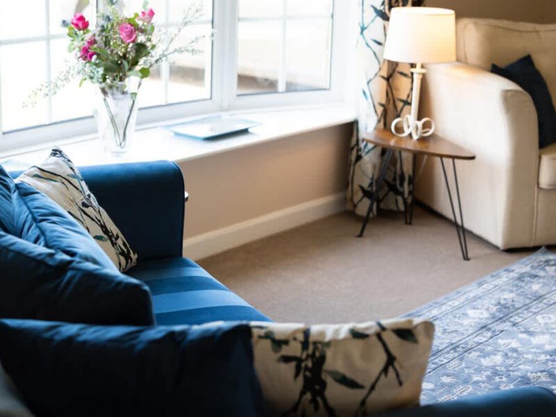 Comfortable seating area with floral accents at Coastal Village Hideaway.