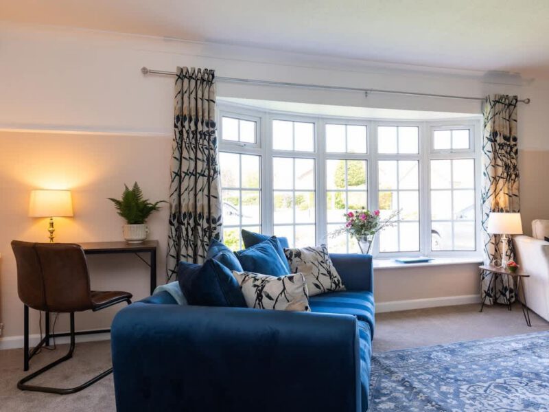 Comfortable living area with bay window at Coastal Village Hideaway holiday let.