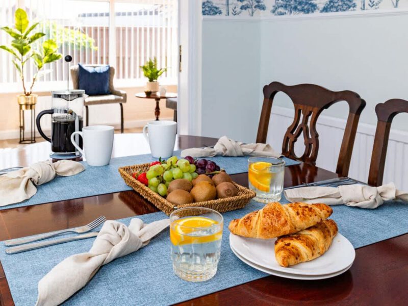 Breakfast spread with croissants and fruit at Coastal Village Hideaway.