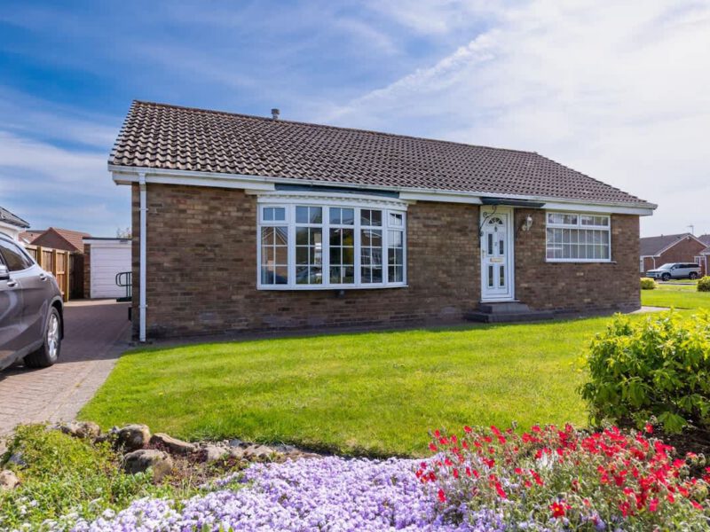 Coastal Village Hideaway holiday cottage with garden and driveway.
