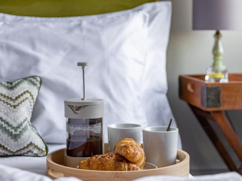 Breakfast tray with coffee and croissants at Crescent View holiday let.