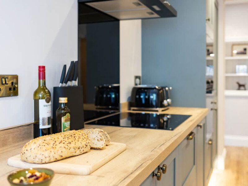 Modern kitchen with bread and wine at Castle View Cottage.