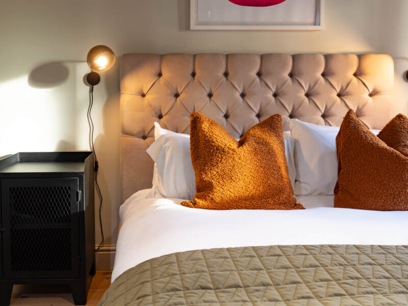 Comfortable bedroom with plush pillows at Old Town House converted church.